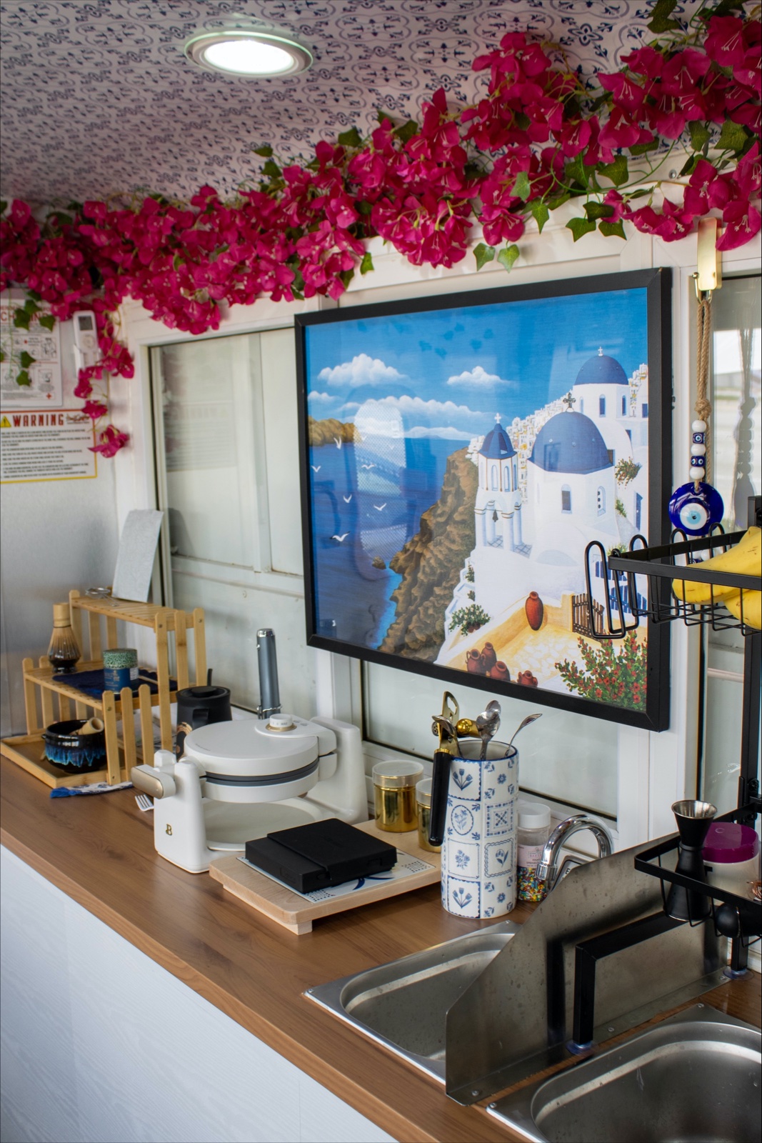 Santorini artwork and bougainvillea inside the truck
