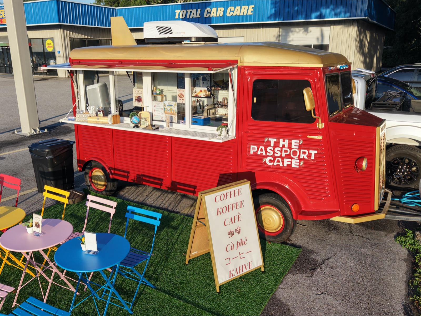 The burgundy truck with colorful bistro tables